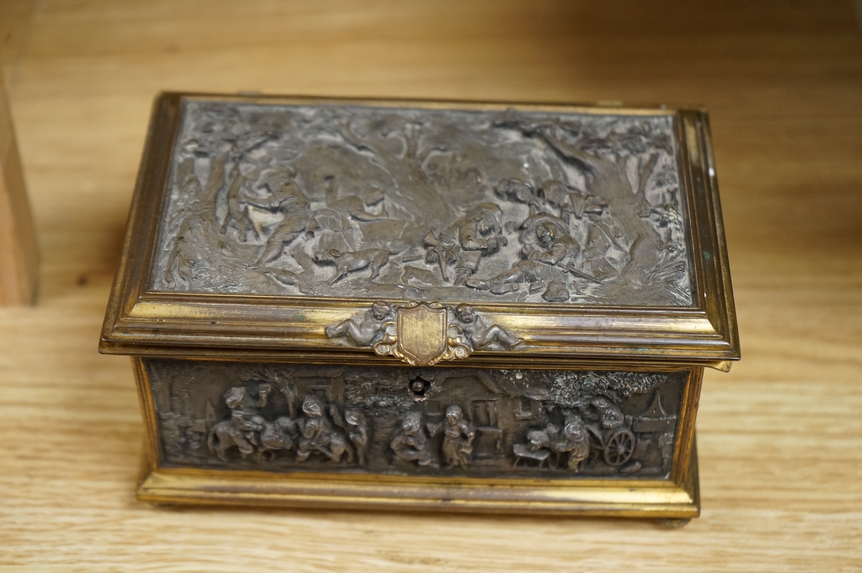 A late 19th century French gilt copper jewellery casket with electrotype relief panels, stamped A B Paris to the base, with key, 14cm wide